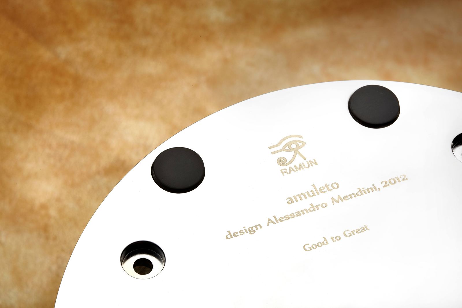 Amuleto base plate engraved with the RAMUN mark and the words design Alessandro Mendini, 2012